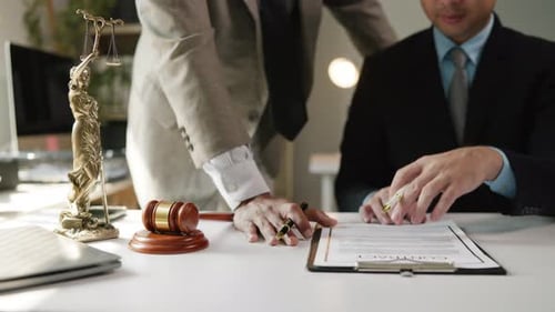 Lawyers Reviewing Contract in Office Setting