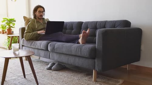 Man On Laptop Having Video Call on Couch