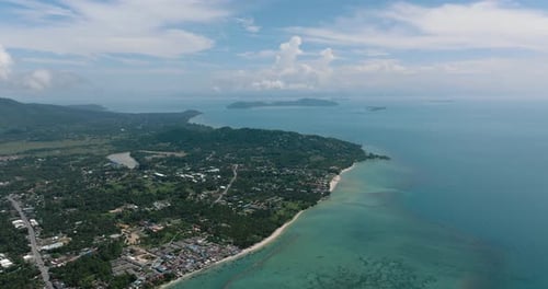 Aerial View of the Coastline with Green Hills and Calm Sea Ko Samui Thailand