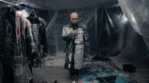 Talented Male Fashion Designer Trying On Freshly Painted Coat in Studio