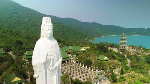 Sweeping Aerial Perspective Revealing Towering White Guan Yin Statue Overlooking Verdant Da Nang