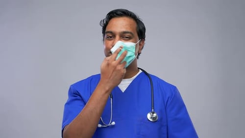 Doctor Takes Off Face Mask and Smiles