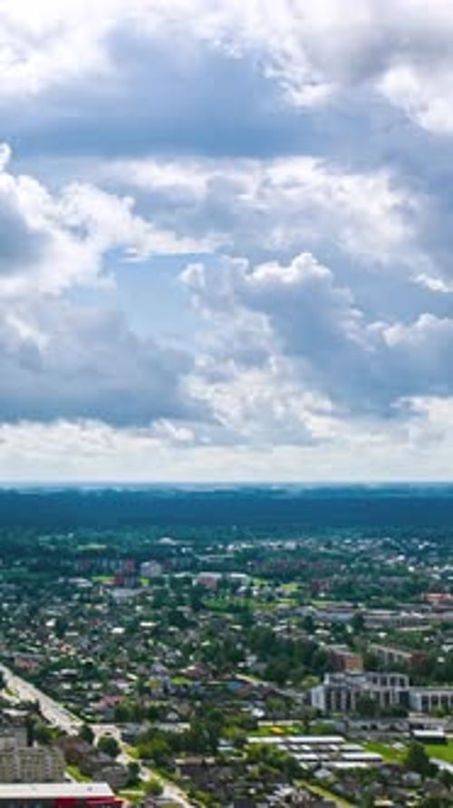 Dynamic Timelapse of Clouds Rolling Over Bustling Cityscape