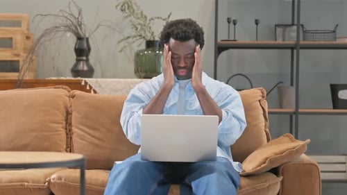 Adult Sitting with Laptop, Rubbing Temples