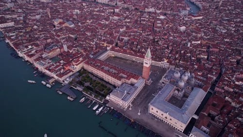 Aerial view of basilica, square, sunrise, and canal, Italy.