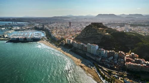 Aerial drone view of the Santa Barbara Castle on the coast of Alicante, Spain with the city and the
