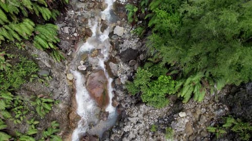Aerial Drone Shot of Sulfur Stream and Waterfall with Reddish Rocks