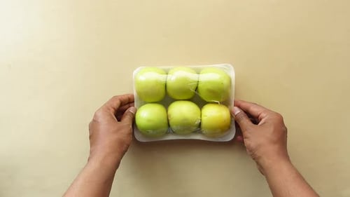 Apples Wrapped in Transparent Plastic