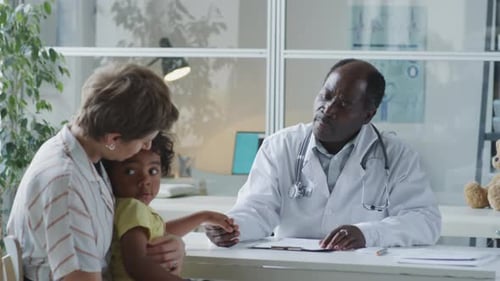 Pediatrician Giving Consultation to Mother and Kid