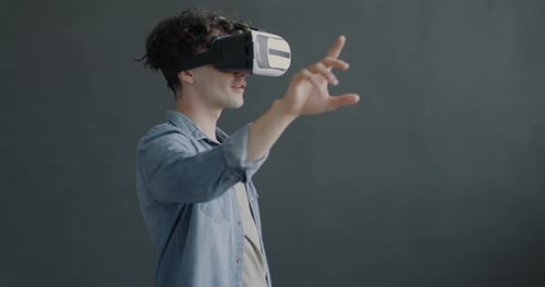 Young Adult Using Virtual Reality Headset to Interact