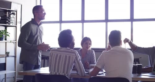 Adults Clapping During Team Meeting in Modern Office