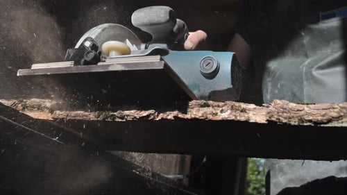 Woodworker Cutting Lumber with Powered Circular Saw