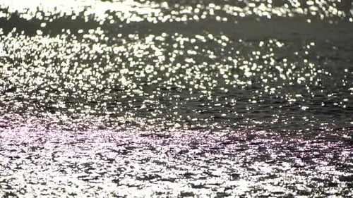 Abstract Shining Sun Reflections on Blue Surface of Sea Waves