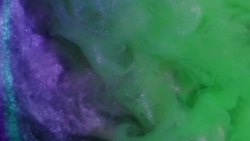 Colorful swirling ink drops spreading in the water