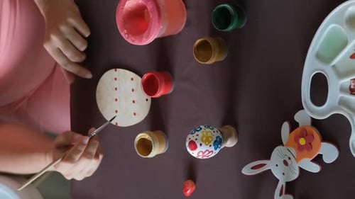 Overhead Easter Decorations Being Painted at Home
