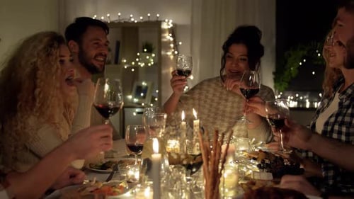 Friends Toasting Wine Glasses at a Dinner Table