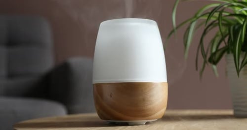 Essential Oil Diffuser On Wooden Table in Home