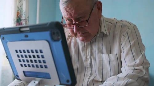 Senior Man Using a Tablet at Home