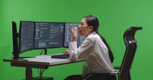 Tired Woman Developer Yawning Before Sleeping While Write Code With Multiple Screens In Green Screen