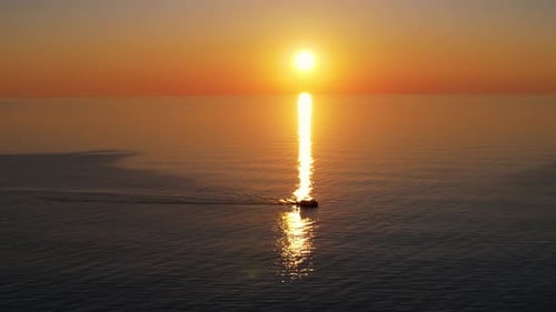 Awesome sea sunset background. Boat sails at the sunset sea.