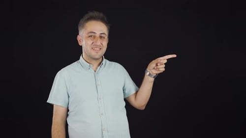 Friendly Man Pointing and Giving Thumbs Up
