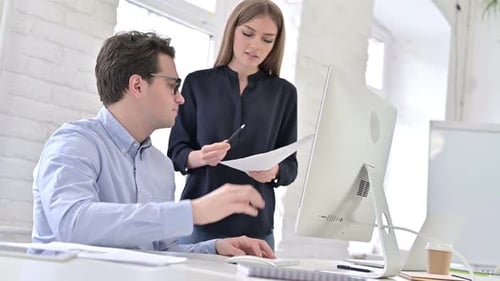 Business Colleagues Discussing Work in Modern Office