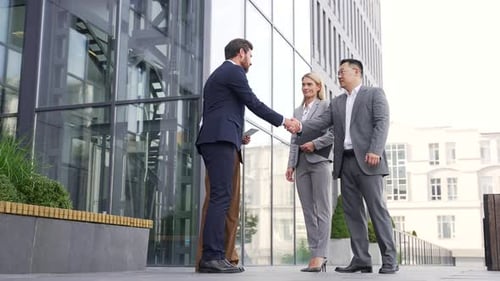 Business People Meeting and Shaking Hands Outside Office