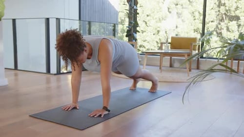 Woman Exercising Doing Mountain Climbers on Yoga Mat