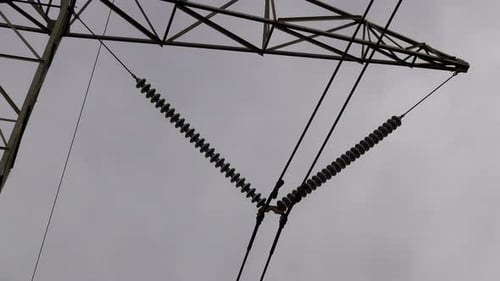 Close-up of electrical insulators on electrical transmission tower.