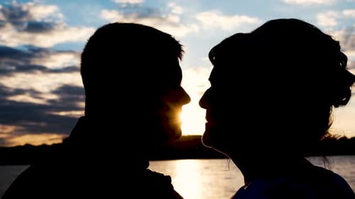 Silhouette of a Couple in Love on the Background of a Beautiful Sunset