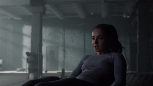 Powerful Woman Training Abdominal Muscles In Dark Gym. Female Bodybuilder Abs Crunch Exercise At ...