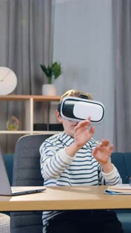 Young Boy Engaged in Virtual Reality at Desk