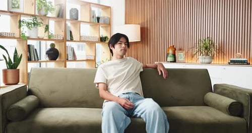 Face, house and happy man on couch, relax and comfortable with weekend break in lounge