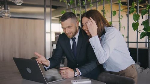 Business Team Collaborates on Laptop in Modern Office
