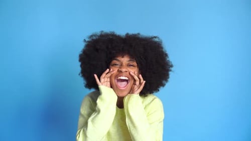 Excited Woman Shouting Announcement Against Blue Backdrop