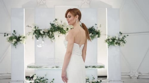 Woman in Wedding Dress Poses in Modern Space Woman in Wedding Dress Poses in Modern Space