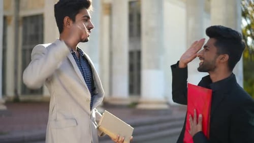 Two Young Adults Celebrating Business Success Outdoors