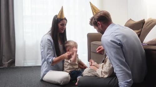 Happy Family Celebrates Birthday Together on Floor