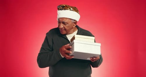 Christmas, gift and shake with old man in studio for mockup, holiday season and boxes