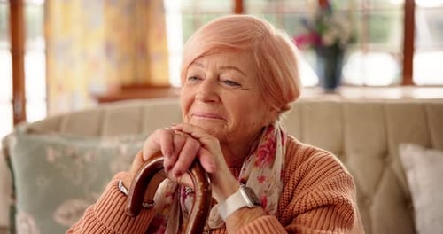 Elegant Senior Woman Resting with Walking Stick