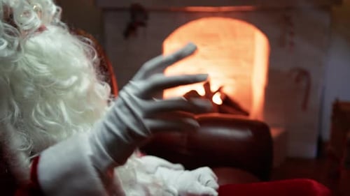 Santa Claus Relaxing by Fireplace at Home