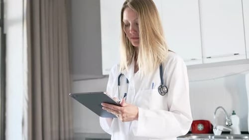 Medical hospital portrait, young blonde woman doctor confident using digital tablet