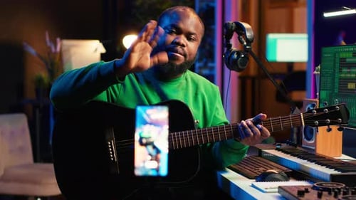 Musician Plays Guitar and Records Video