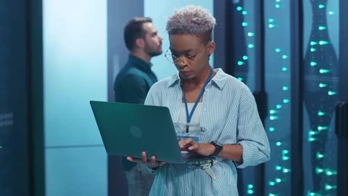 Innovative Tech Professionals Engaging in Collaborative Efforts Within a Modern Data Center