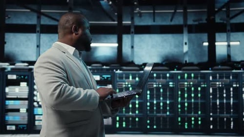 Programmer in Data Center Using Laptop Employing AI Machine Learning Models