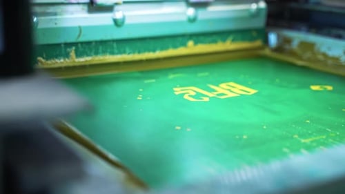 Printing Press Machine Applies Yellow Paint to Design