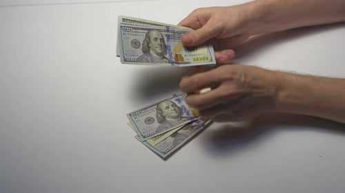 Hands Count Stack of One Hundred Dollar Bills