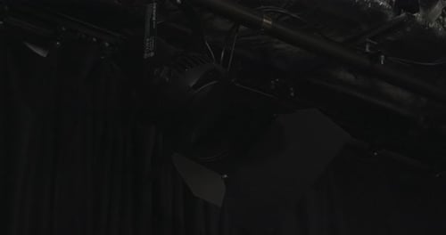 Close up on ETC Desire D40 LED light switching on and off in overhead studio rigging