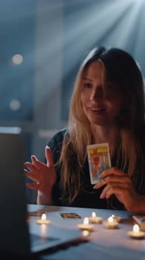 Young Woman with Tarot Cards in Candle Light