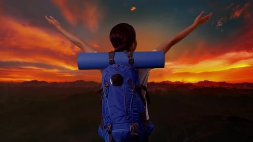 Back View Of A Female Hiker Spreading Arms And Looking The View Around On The Top Of Mountain